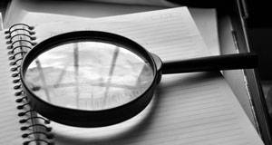 image of magnifying glass on notebook